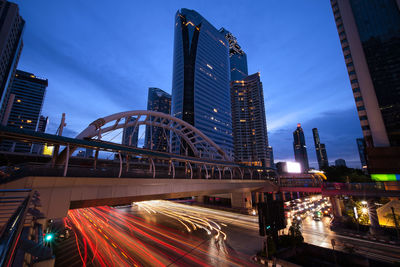 Buildings and bridge in city at dusk