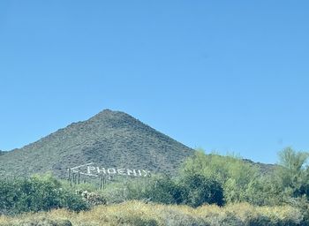 Scenic view of mountains against clear blue sky