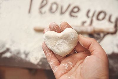 Close-up of hand holding heart shape cookies