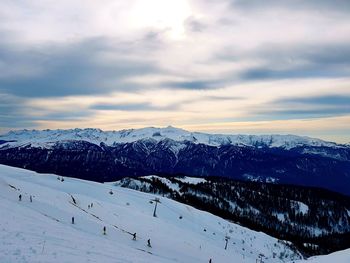 Snow covered mountain against cloudy sky