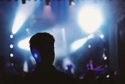 Rear view of silhouette man at popular music concert