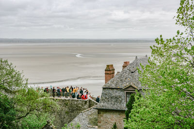 High angle view of buildings by sea against sky