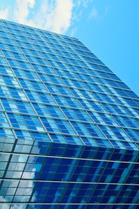 Low angle view of modern building against blue sky