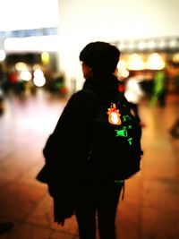 Rear view of man standing at night