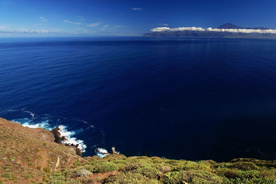 Scenic view of sea against blue sky