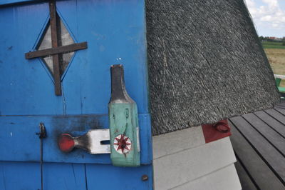 Wooden post on table against blue wall