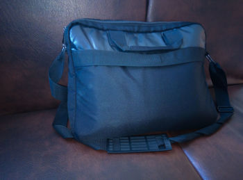 High angle view of messenger bag on sofa at home