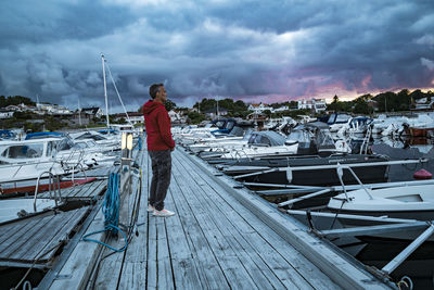 Rear view of man standing on pier