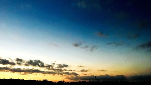 Low angle view of silhouette landscape against sunset sky