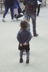 Rear view of people walking on street