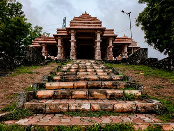 View of old temple against cloudy sky