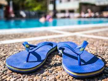 Close-up of shoes on beach