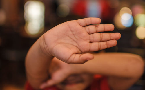 Close-up of a boy covering face