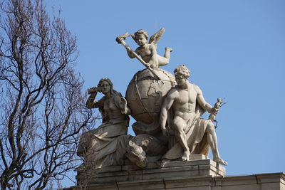 Low angle view of statue against clear blue sky