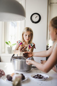 Girls making food in kitchen