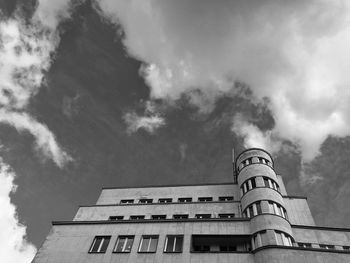 Low angle view of building against cloudy sky