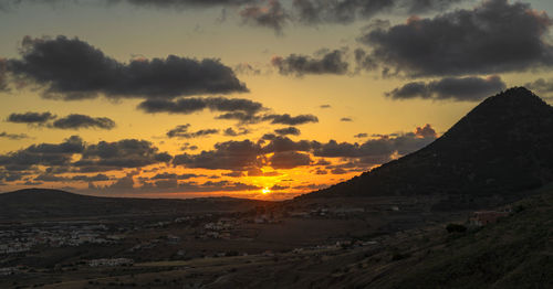 Scenic view of dramatic sky during sunset