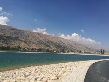 Scenic view of land and mountains against sky