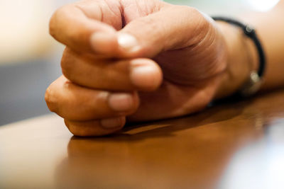 Close-up of hands holding table