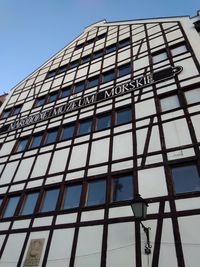 Low angle view of modern building against clear blue sky