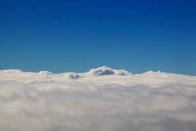 Scenic view of snowcapped mountains against blue sky