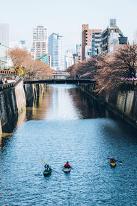 High angle view of people on river in city