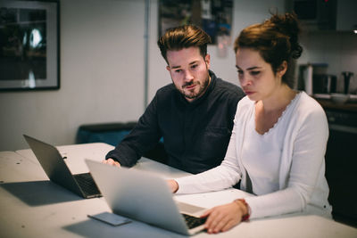 Young couple working on table