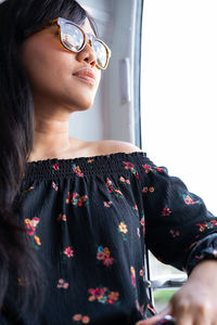 Low angle view of woman looking through window