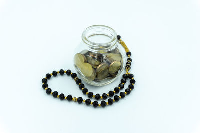 High angle view of decoration in glass jar on white background