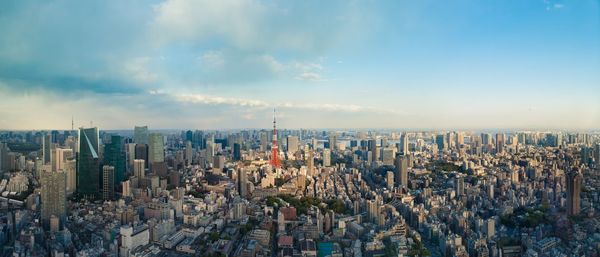 Panoramic shot of modern buildings in city against sky