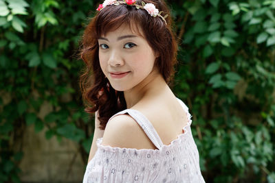 Portrait of beautiful young woman standing outdoors