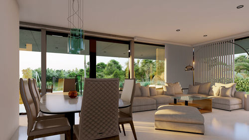 Spacious light lounge zone with elegant comfortable furniture and modern interior design in luxury villa in countryside