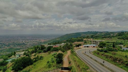 High angle view of road amidst trees against sky