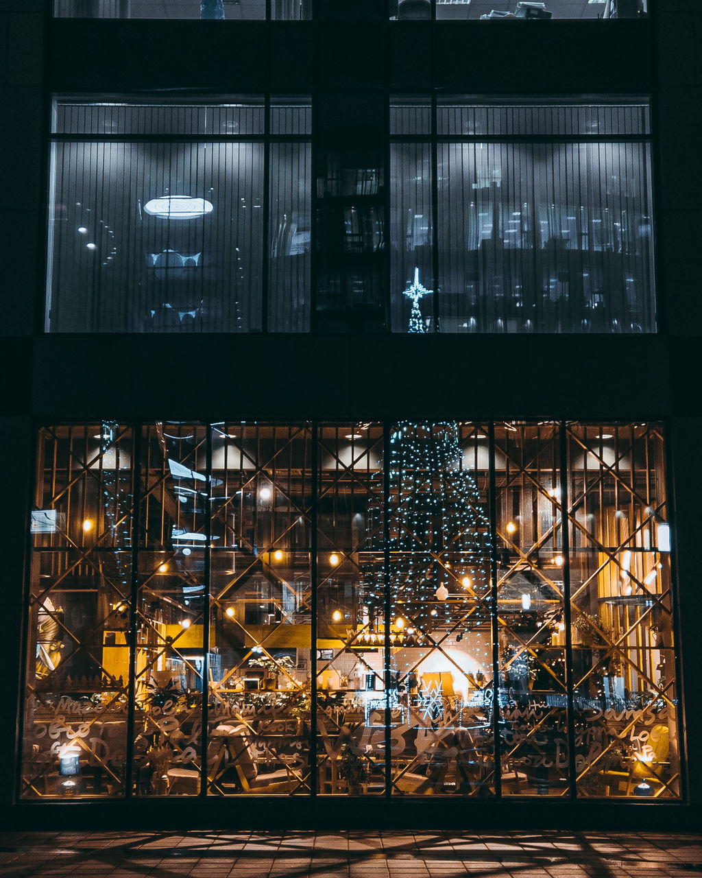 illuminated, night, architecture, lighting equipment, built structure, glass - material, no people, building exterior, window, transparent, city, outdoors, street, street light, light, building, electricity, low angle view, glowing, reflection, window frame