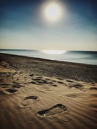 Scenic view of beach against sky during sunset