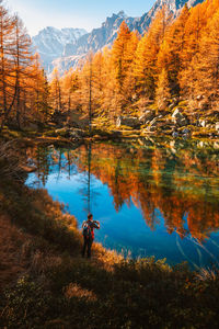Scenic view of lake and mountains against sky during autumn
