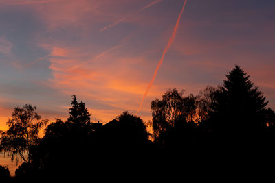 Low angle view of silhouette trees against sky during sunset