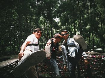 People standing by trees against plants