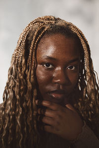 Portrait of young woman with braided hair in studio