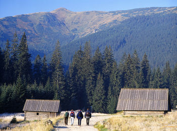 People walking towards mountains