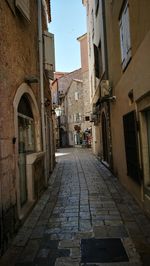 Narrow alley amidst buildings in city