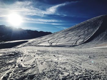 Snow covered landscape against sky