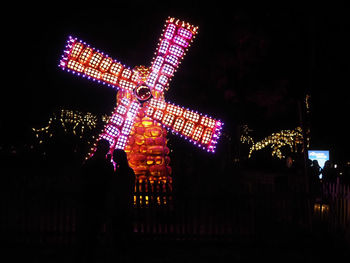 Low angle view of illuminated building against sky at night