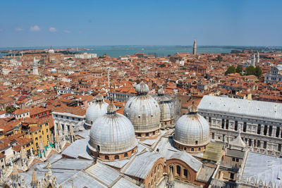 High angle view of townscape by sea against sky