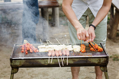 Midsection of man preparing food