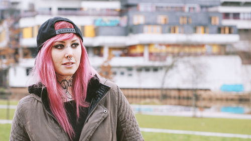 Portrait of young woman standing outdoors