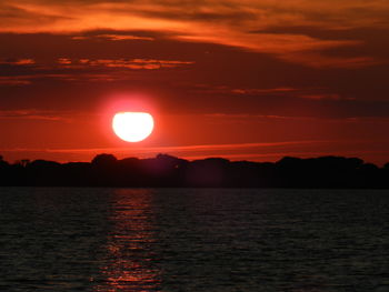 Scenic view of sea against romantic sky at sunset