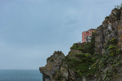 Scenic view of sea by buildings against sky