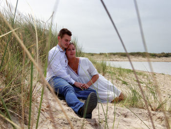 Young couple sitting on land