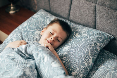 High angle view of baby sleeping on bed